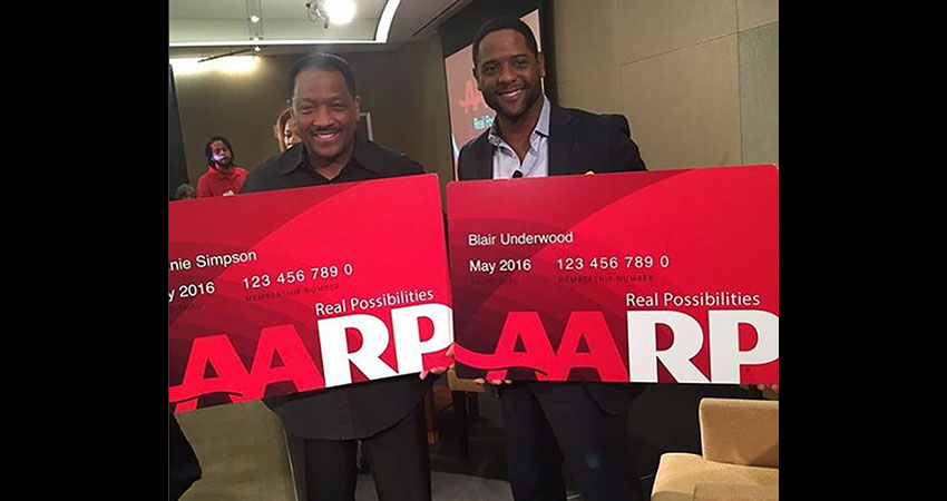 Donnie Simpson and Blair Underwood holding AARP membership cards